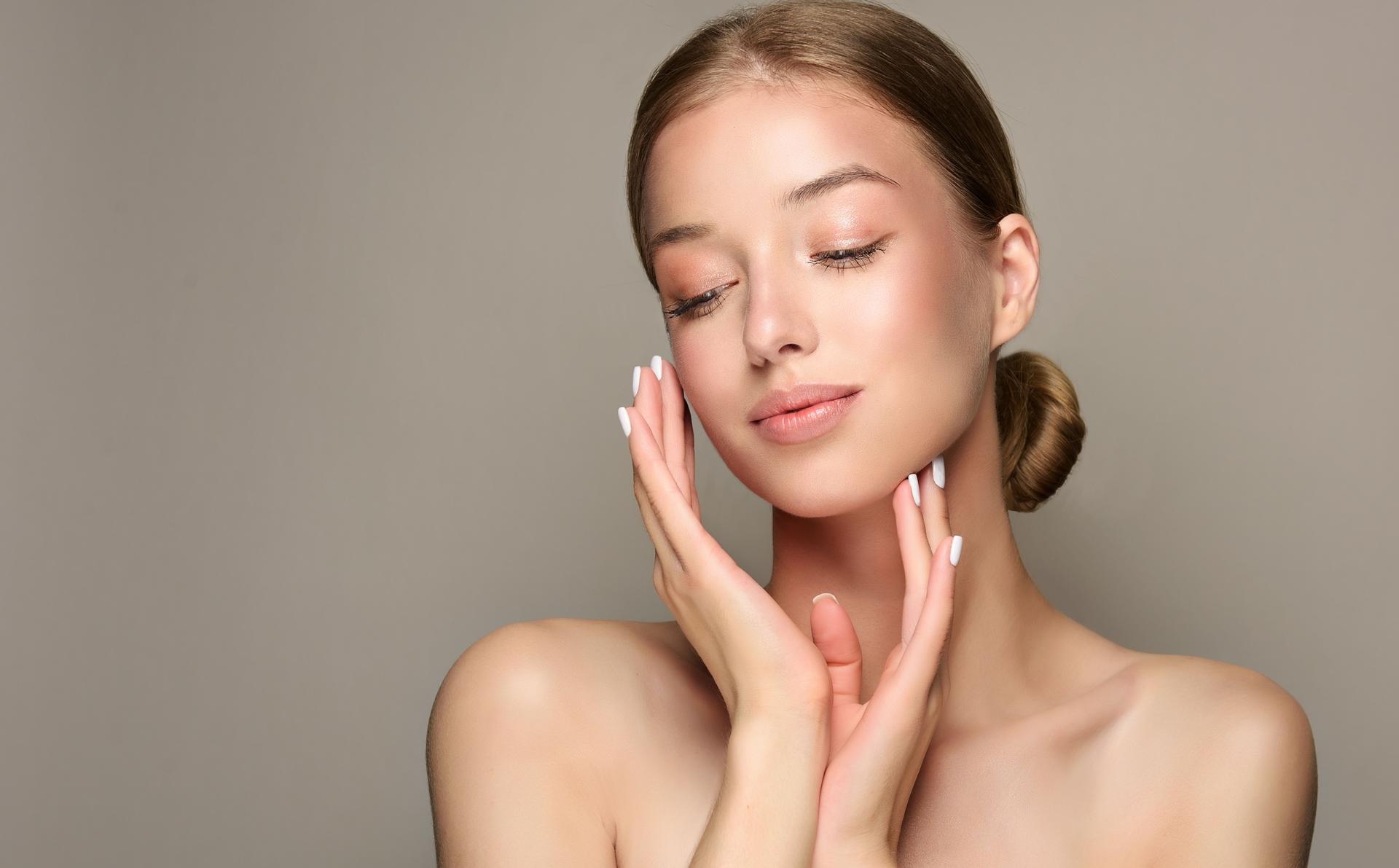 Portrait of gorgeous young woman with hair gathered in the bun and delicate makeup on the face.. Cosmetology.